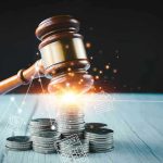 Gavel, coins, and tax icons on a table