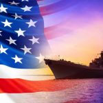 American flag overlaying warship at sunset