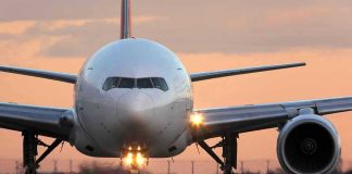 Airplane on runway during sunset