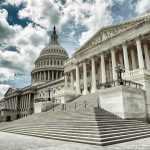 The US Capitol building with a cloudy sky backdrop