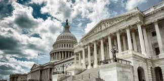 The US Capitol building with a cloudy sky backdrop