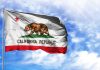 California Republic flag waving against blue sky.