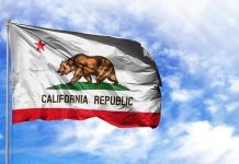 Katie Porter’s $16,000 Hypocrisy BOMBSHELL California Republic flag waving against blue sky.