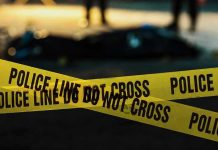 Knife-Wielding Grandma Storms Florida Home Police tape marking a crime scene at night.