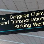 Airport sign for Baggage Claim and other destinations