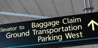 Airport sign for Baggage Claim and other destinations