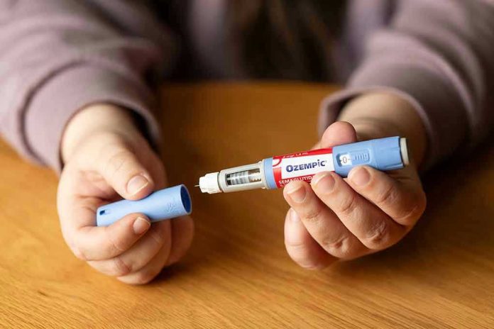 Hands holding an Ozempic injection pen.
