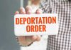 Military Forces SEAL Borders – Unprecedented Move Hand holding sign with Deportation Order text.