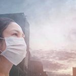 Person wearing a mask in a cityscape background.