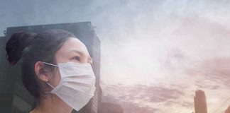 Person wearing a mask in a cityscape background.