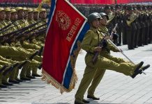Military Alliance SHOCKS — Unprecedented North Korea-Russia Deal Soldiers marching with rifles and a red flag