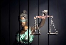 UKRAINIAN Refugee MURDERED — Negligent Judges EXPOSED Blindfolded Lady Justice statue holding scales behind bars.