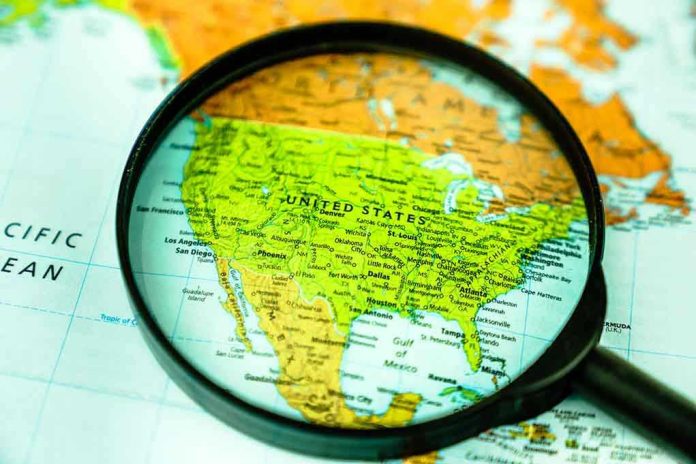 1635435619 Magnifying glass over United States on map.