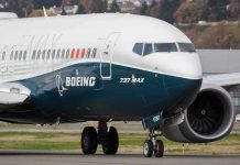 Boeing 737 MAX airplane on runway.