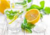 A refreshing drink with lemon slices and mint leaves in a clear glass