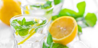 A refreshing drink with lemon slices and mint leaves in a clear glass