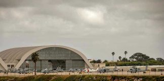 Aircraft hangar with helicopters near the beach.