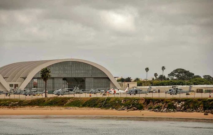 1086141389 Aircraft hangar with helicopters near the beach.