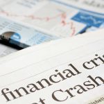 Close-up of a newspaper headline about a financial crisis