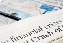 Close-up of a newspaper headline about a financial crisis