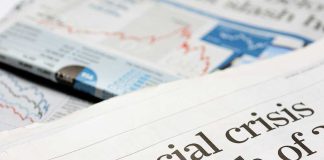 Close-up of a newspaper headline about a financial crisis