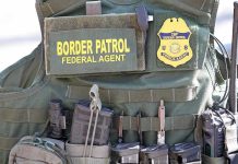 ICE’s SHOCKING $100M Recruitment Blitz Exposed Border Patrol vest with gear and communication equipment.
