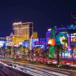 Vibrant view of the Las Vegas Strip at night with neon lights and traffic