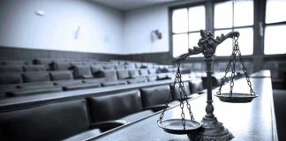 Stunning Ruling! Judge Condemns Search Yet Saves Evidence Scales of justice in an empty courtroom.