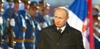Putin’s Shocking Ukraine Endgame Claim: Can It Be True? A man in dark coat at a military event.