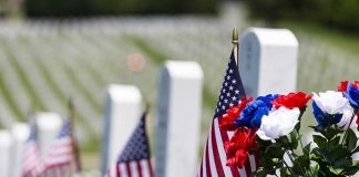 The Old Guard’s Stunning Memorial Day Tribute American flags and flowers placed at graves in a cemetery