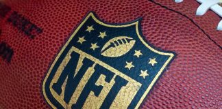 Ex-NFL Star in $197M Fraud: Shocking Twist Close-up of an NFL football with the logo prominently displayed