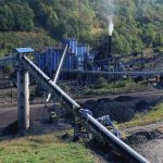 Coal Revival Plan Tests U.S. Energy Security Industrial coal processing plant with conveyor belts and smokestack.