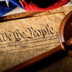 Judge Arrested After Parking-Lot Dispute Gavel on U.S. Constitution with flag backdrop.