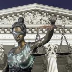 Secret Affair Inside Courtroom Triggers Ethics Firestorm Lady Justice statue in front of courthouse.
