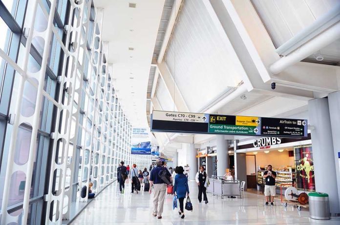 99344561 Interior of an airport terminal with travelers and signage