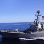 US Proposal: Paid Navy Escorts for Tankers in War Zone A naval destroyer sailing in the ocean with an American flag