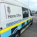 U.S. Raids: Immigration Fight Goes Global White immigration enforcement van parked by roadside