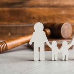 Paper cutout family with gavel in background