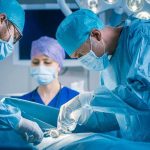 Surgeons perform an operation in a hospital operating room