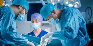 6-Year-Old Dies After Experimental Gene-Editing Trial Surgeons perform an operation in a hospital operating room
