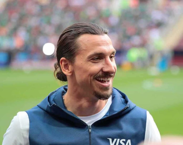 shutterstock_1359218810 smiling man with tied-back hair at a sports stadium