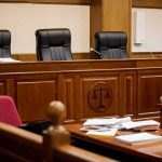 Billionaire’s AI-Era Fortune Fuels $640M Divorce empty courtroom with judge's bench and microphones