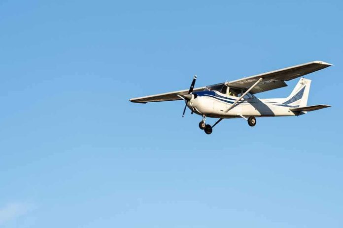 shutterstock_2136488743 Single-engine airplane flying against clear blue sky