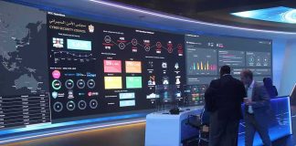 A Database Change Revealed a Higher Human Cost cybersecurity operations room with large data dashboards and people discussing