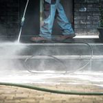 Worker pressure washing outdoor steps