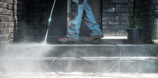 Cancer Fears Prompt Orange County to Halt Pesticide Spraying Worker pressure washing outdoor steps
