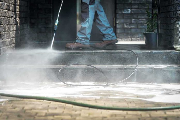 Worker pressure washing outdoor steps