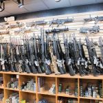 Wall of rifles and shotguns in a gun store