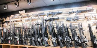 DOJ Unmasks 140-Gun Pipeline Wall of rifles and shotguns in a gun store