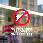 No firearms allowed sign on a store window